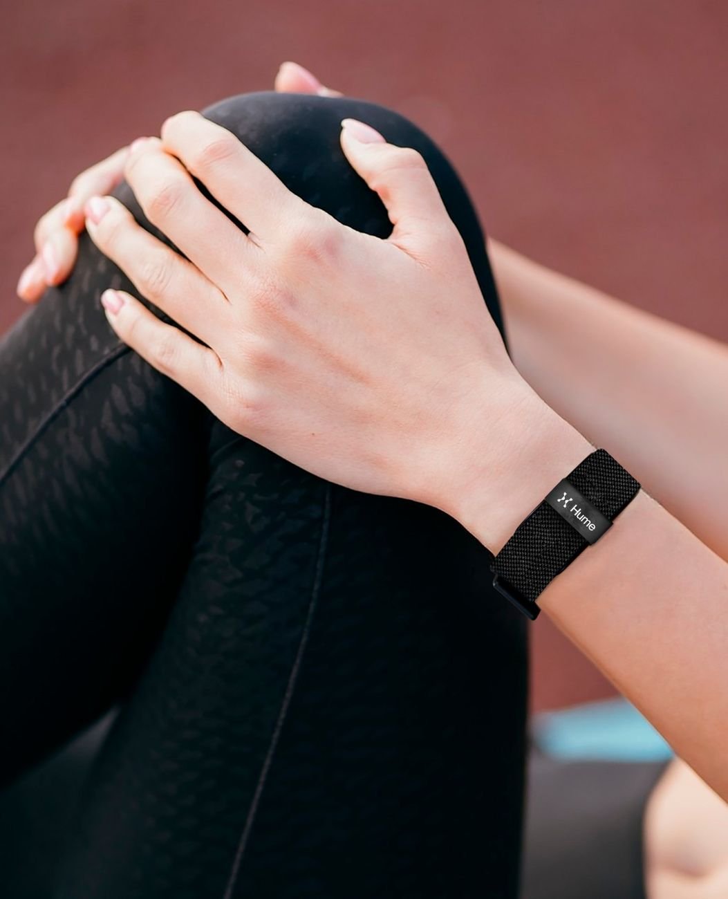 Close-up of a wrist wearing Hume Band during a stretching routine